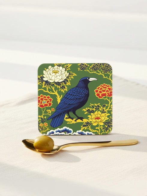 Grimoire and Goblet set of 4 glossy square coasters featuring Chinoiserie style raven illustrations. 1: Navy blue with blue floral pattern and raven. 2: Navy background with black raven, white full moon, and red berries. 3: Moss green background with blue bird and yellow chrysanthemums. 4: Black background with teal-winged raven and red peonies. MDF hardboard with cork backing. Flat vector botanical art style.