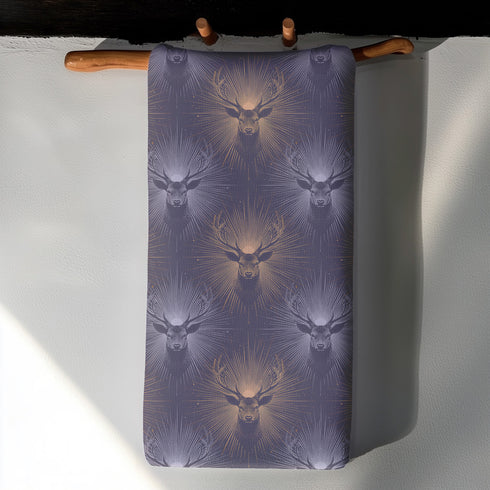 Set of four slate blue dining napkins featuring alternating gold and silver ravens in flight with botanical accents, sized 18x18 inches.