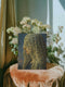 A rectangular matte canvas art print featuring a surrealist portrait of a woman in profile against a dark, cloudy sky. Her face is obscured by a delicate, translucent veil adorned with a repeating pattern of blue and gold all-seeing eyes. Several eyes are shedding deep blue tears that drip down the fabric. The artwork employs a classical, painterly style with a moody palette of blues, golds, and deep shadows, evoking a gothic and enigmatic atmosphere.