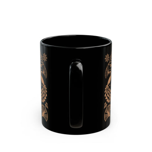 A black ceramic mug featuring an Art Deco-inspired design in rose gold. The symmetrical pattern shows two peacocks with fan-shaped tails, surrounded by ginkgo fan motifs and floral elements. The central design includes a stylized flower with leaves, and decorative stars accent the composition. The mug has a classic C-shaped handle.