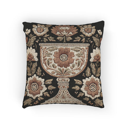 Woven tapestry pillow, 17" x 18", featuring an ornate chalice framed by botanical motifs in ivory, rust, and olive on a black ground. Artisan-woven of 58% cotton, 42% polyester and stuffed with soft, durable polyfill. Sewn shut for a smooth, seamless finish. Double-sided pattern for full visibility. Dark-academia, mystical décor accent; folklore-inspired woven pillow for sofa, chair, or bed.