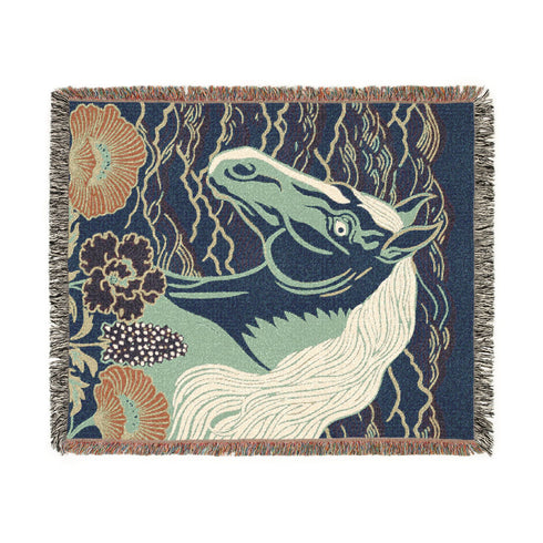 A Grimoire and Goblet woven cotton blanket featuring a large, stylized horse head in sage green and teal against a deep midnight navy background with wave patterns. The bottom edge features woven floral motifs in rust orange and deep plum. The design is a jacquard weave, not printed, with visible thread texture and multi-colored fringe edges. Chinoiserie and Art Nouveau style equestrian tapestry throw.