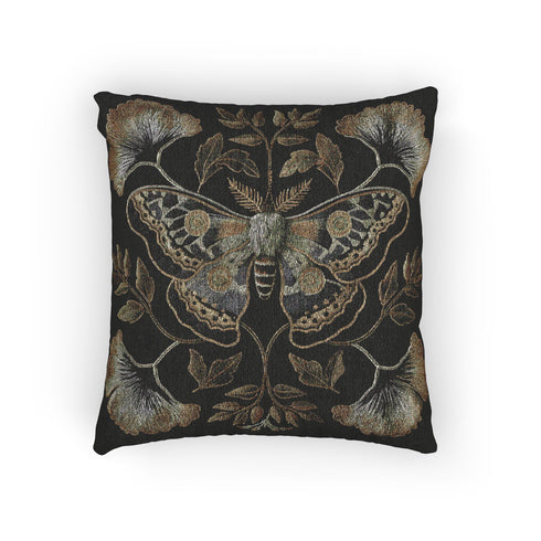 A square decorative pillow featuring an intricately detailed Luna moth in sage green and olive tones on a black background. The moth is centered in a symmetrical arrangement with ginkgo-like leaves and botanical elements surrounding it.