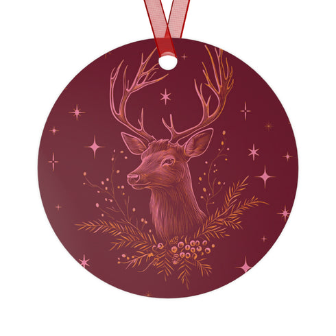 Round metal ornament featuring detailed rose gold etching of a stag's profile with antlers, surrounded by winter foliage and stars on burgundy background. 3.5-inch diameter piece with crimson ribbon. Double-sided woodland artwork.