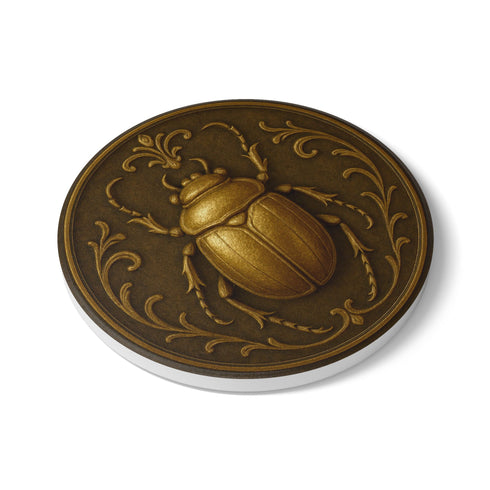 Round ceramic coaster featuring a raised bronze-tone scarab beetle and ornate filigree motif on a matte dark brown glazed surface; 4-inch diameter; backed with cork for non-slip protection; heat-resistant and easy-wipe; perfect for hot or cold beverages in mystical, dark-academic, or antique-inspired interiors.