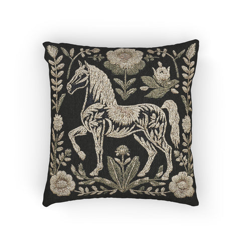 A premium, artisan-woven accent pillow from Grimoire and Goblet. The pillow is 17x18 and features a highly detailed, double-sided jacquard design on a deep black background. The artwork, woven in neutral gold, ecru, and muted olive threads, depicts a mystical, folkloric horse. This central horse figure is surrounded by a lush, symmetrical border of botanical flowers and leaves. The style is evocative of a medieval tapestry, perfect for dark academia, gothic, or arcane-themed decor.