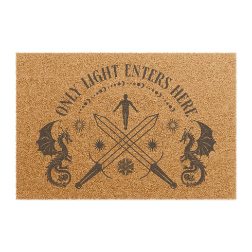 Coir doormat with "Only Light Enters Here" text, two dragons, crossed swords, and a celestial figure, all in dark brown on natural tan background.