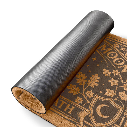 A rectangular natural tan doormat featuring a gothic celestial moon phase design in high-contrast black ink. The central crescent moon is detailed with mystical flourishes and surrounded by a symmetrical line of moon phases and twinkling stars. This 2D flat print is applied to coarse, tufted coconut coir fiber for a vintage grimoire aesthetic. The doormat includes a heavy-duty black vinyl non-slip backing and is designed as a functional accent for a dark academia or witchy porch entryway.
