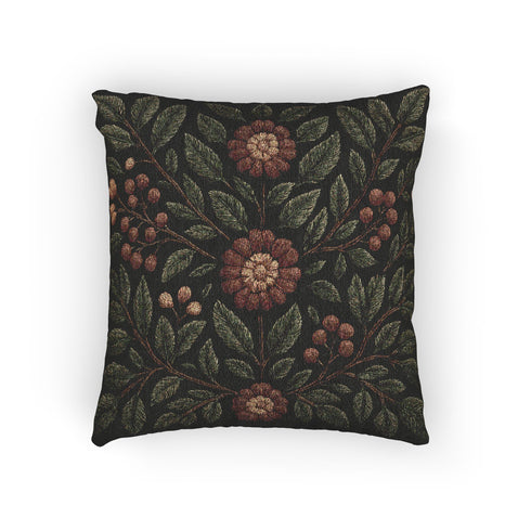 A 17x18 inch woven tapestry pillow featuring a dark green background with embroidered rowan leaves, berries, and rust-toned flowers. The pillow is double-sided, filled with plush poly fill, and sewn shut for a seamless, soft finish. Made from 58% cotton and 42% polyester yarns, this decorative cushion adds a cozy, mystical charm to any cottagecore, gothic, or forest-inspired home.