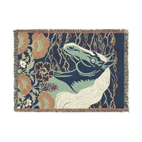 A Grimoire and Goblet woven cotton blanket featuring a large, stylized horse head in sage green and teal against a deep midnight navy background with wave patterns. The bottom edge features woven floral motifs in rust orange and deep plum. The design is a jacquard weave, not printed, with visible thread texture and multi-colored fringe edges. Chinoiserie and Art Nouveau style equestrian tapestry throw.