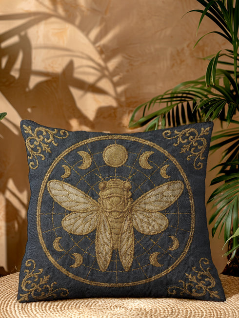 A square woven tapestry pillow in charcoal grey and metallic gold thread, exuding a premium, artisan quality. The central design features a large, detailed cicada, a key motif in entomology decor, encircled by celestial moon phases. This blend of mystical and dark botanical elements is ideal for Whimsigoth, Gothic, and Dark Academia aesthetics. Ornate Victorian flourishes in the corners complete this luxurious, double-sided piece of functional art, perfect as a statement pillow.
