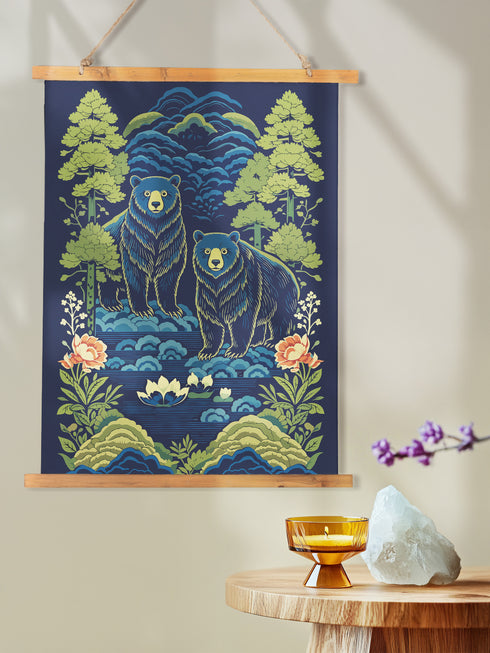 A vertical William Morris style art tapestry featuring a stylized brown bear surrounded by intricate Chinoiserie floral patterns in deep jewel tones of forest green, gold, and burgundy. The artwork is printed on soft, silky polyester fabric that drapes smoothly. The tapestry is mounted on a rustic stained wooden hanger with a twine cord for wall display. This wall hanging combines Dark Academia and Cottagecore aesthetics, reflecting the mystical design quality of Grimoire and Goblet products.