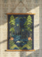 A vertical William Morris style art tapestry featuring a stylized brown bear surrounded by intricate Chinoiserie floral patterns in deep jewel tones of forest green, gold, and burgundy. The artwork is printed on soft, silky polyester fabric that drapes smoothly. The tapestry is mounted on a rustic stained wooden hanger with a twine cord for wall display. This wall hanging combines Dark Academia and Cottagecore aesthetics, reflecting the mystical design quality of Grimoire and Goblet products.