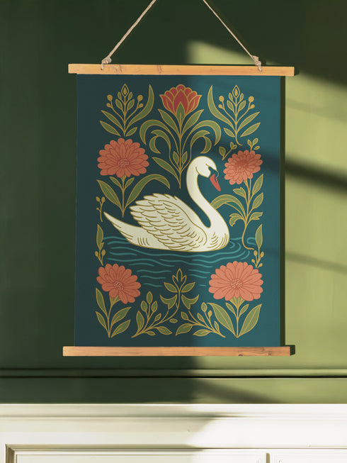A 26x36 inch Art Nouveau wall scroll from Grimoire and Goblet. Crafted from silky premium polyester, it features a white swan with gold-accented feathers gliding through blue-green water, framed by vining olive foliage and salmon-pink chrysanthemums. A red-orange tulip blooms at the top. Suspended from stained wooden dowels with a natural twine rope, this tapestry evokes a mystical, gothic-botanical elegance.