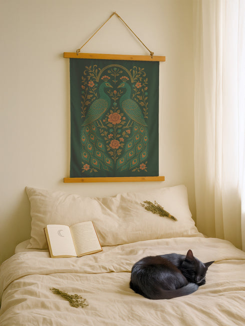 Vertical tapestry wall art measuring 26"x36" featuring two peacocks surrounded by floral vines in gold and teal on a deep green background. Includes a wooden top and bottom hanger with twine for easy wall mounting. Made of smooth polyester with a soft sheen and vibrant print. Ideal for gothic, botanical, or whimsical decor themes.