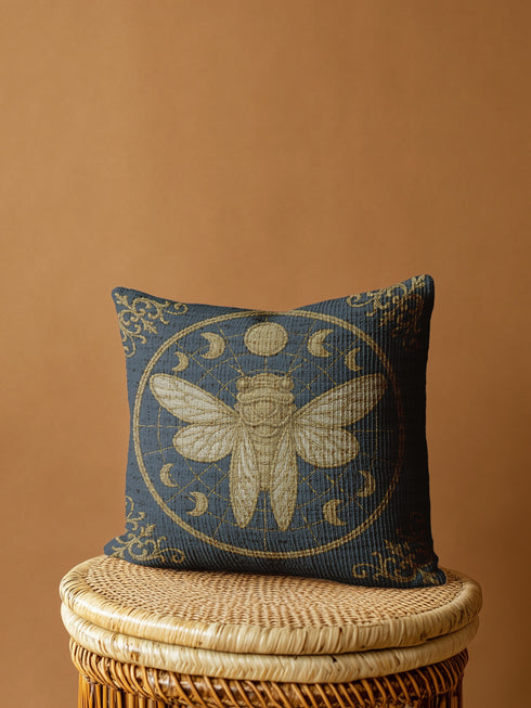 A square woven tapestry pillow in charcoal grey and metallic gold thread, exuding a premium, artisan quality. The central design features a large, detailed cicada, a key motif in entomology decor, encircled by celestial moon phases. This blend of mystical and dark botanical elements is ideal for Whimsigoth, Gothic, and Dark Academia aesthetics. Ornate Victorian flourishes in the corners complete this luxurious, double-sided piece of functional art, perfect as a statement pillow.