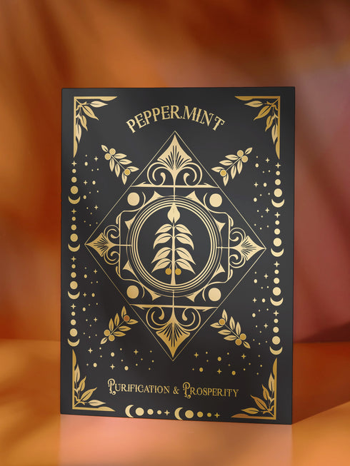 a black and gold playing card with a picture of a tree