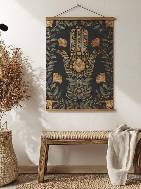 a Botanical Hamsa wall tapestry featuring gold and teal design on black background, showing a protective hand symbol adorned with leaf motifs and floral elements, hanging from wooden dowels with natural twine.