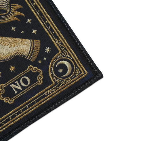 Grimoire and Goblet witchy doormat featuring a deep navy background with antique gold faux embroidered design of a crystal ball with central eye, surrounded by crescent moons, stars, and pointing hands, with ornate border and banner details, rectangular entryway rug with black trim and non-slip backing, mystical occult home decor mat for indoor or covered outdoor use