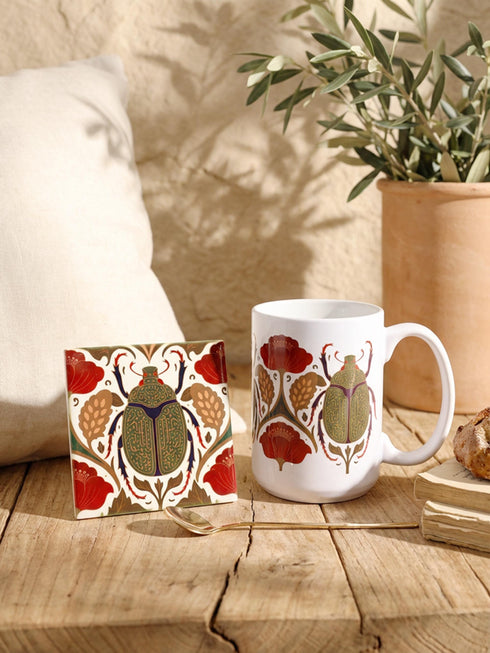 A luxury gift set featuring a matching ceramic mug and square coaster with a vintage entomology design. The artwork depicts a vibrant green Scarab beetle with iridescent wings, surrounded by dark moody floral botanicals in rust and ochre, set against a creamy background in a Victorian naturalist style. The mug is 15oz with a large handle and full wrap design. The coaster is glazed ceramic tile with a cork backing. Perfect for Dark Academia and Grimoire and Goblet gothic home decor.