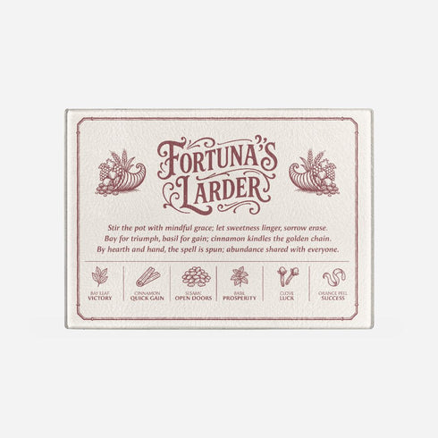 A rectangular tempered glass cutting board with a lightly textured, hygienic surface, rounded corners, and four rubber feet for stability. Printed in deep maroon line art, it features a Victorian-style border and twin cornucopias flanking the title “Fortuna’s Larder.” Below, a poetic spell invokes abundance, followed by six herb correspondences: Bay Leaf Victory, Cinnamon Quick Gain, Sesame Open Doors, Basil Prosperity, Clove Luck, and Orange Peel Success, for kitchen witches and magical cooks.