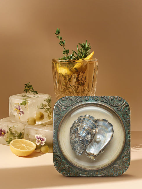 A high-fidelity 2D Trompe-l’œil print on a set of four 4x4 inch square coasters. Each coaster features a centralized sea specimen—a scallop, an oyster with a pearl, a pink conch, and an abalone—centered within an ornate, circular Victorian scrollwork frame. The design uses a faux-texture effect to mimic raised bronze and verdigris metal. The colors include aged gold, teal, and cream, creating a vintage museum specimen aesthetic