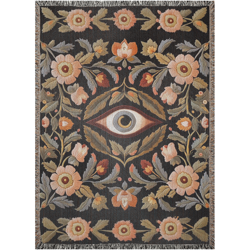A luxury woven jacquard blanket in three sizes featuring an all-over wild herb botanical pattern of stylized blossoms and foliage in muted gold, olive, lavender, and pewter on a deep black cotton ground; finely twisted multicolor fringe edges complete the artful tapestry weave, ideal as a cozy sofa throw or dramatic wall hanging.