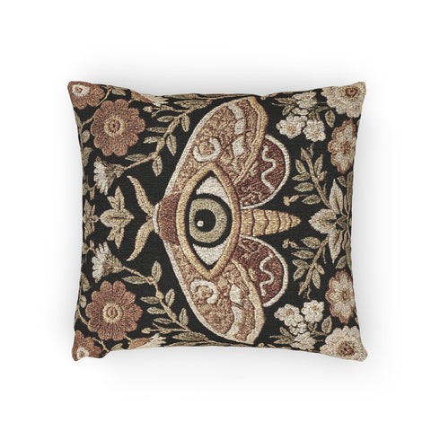 Woven tapestry pillow, 17" x 18", featuring a central moth with an eye and vintage florals in cream, rust, and olive on a black ground. Artisan-woven of 58% cotton, 42% polyester; stuffed with soft polyfill. Sewn-shut closure; double-sided pattern for full visibility. Botanical, symbolic woven pillow—folklore-inspired accent for couches, reading nooks, or beds.