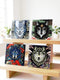 Set of 4 square tempered glass coasters featuring a mystical wolf design on a black background. High-gloss finish with non-slip rubber feet. Dark Academia and Whimsigoth aesthetic home decor. Close-up detail shows grey wolf fur texture and amber eyes. Durable drinkware protection for wooden tables. Grimoire and Goblet gothic luxury barware accessory for coffee tables and desks. Heat resistant glass surface with polished edges.