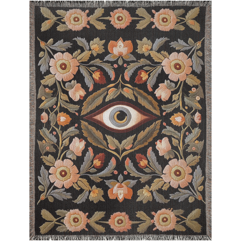 A luxury woven jacquard blanket in three sizes featuring an all-over wild herb botanical pattern of stylized blossoms and foliage in muted gold, olive, lavender, and pewter on a deep black cotton ground; finely twisted multicolor fringe edges complete the artful tapestry weave, ideal as a cozy sofa throw or dramatic wall hanging.