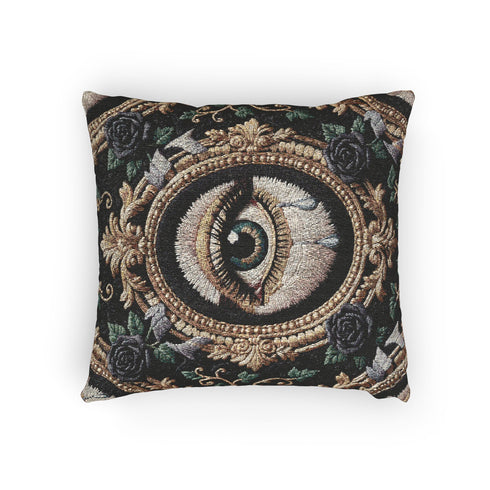 A square woven tapestry throw pillow by Grimoire and Goblet featuring a striking gothic design. The central motif is a large, detailed eye with a teal iris and light blue teardrops, set against pale skin. This eye is encased in an ornate, gold-toned baroque oval frame. The background is deep black, adorned with dark mauve roses and muted green foliage in the corners. The texture is a rich weave.