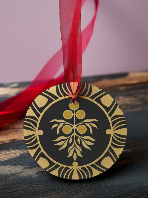 Round metal ornament featuring golden juniper berry branch design with Art Deco-inspired geometric border on black background. 3.5-inch diameter piece with botanical motif and crimson ribbon. Double-sided detailed artwork.