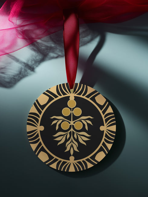 Round metal ornament featuring golden juniper berry branch design with Art Deco-inspired geometric border on black background. 3.5-inch diameter piece with botanical motif and crimson ribbon. Double-sided detailed artwork.