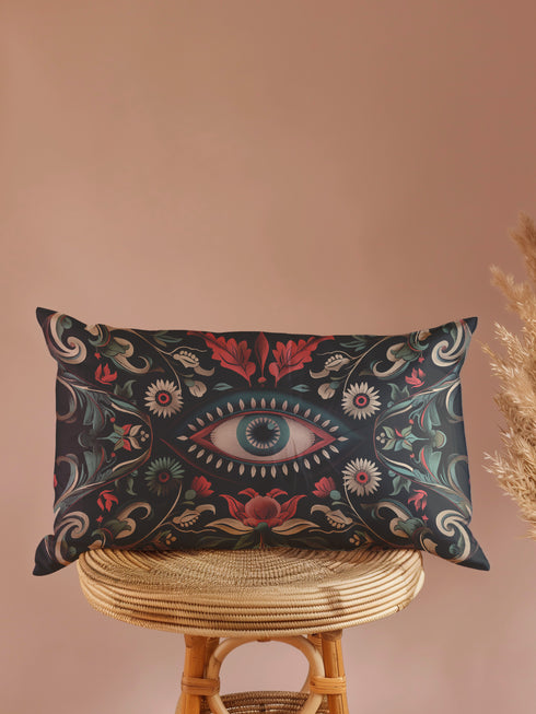 Black lumbar pillow cover featuring an ornate evil eye design with detailed floral motifs in red, cream, and green, framed by gold accents.