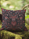 Woven throw pillow featuring an embroidered stag with antlers entwined in red and teal florals, set against a black background.