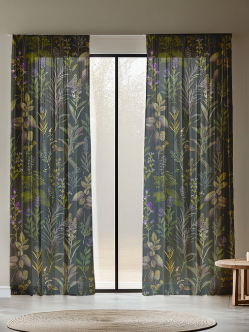 Sheer curtain panel featuring an intricate vertical pattern of wild botanicals including purple flowers, golden leaves, and silvery fronds against a dark charcoal background. The design shows detailed herbarium-style illustrations.
