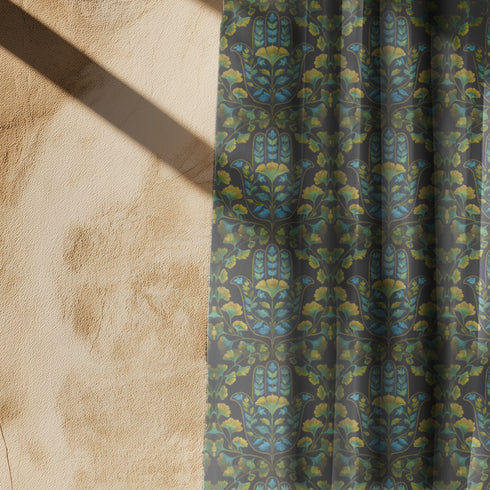 Sheer curtain panel featuring repeating pattern of golden yellow ginkgo leaves with teal hamsa-shaped botanicals on dark background. Linen-textured polyester fabric filters light while providing elegant window covering with protective botanical symbolism.