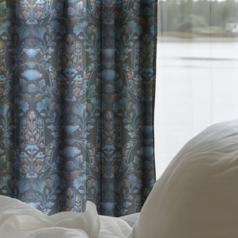 Sheer curtain panel featuring repeating gold hamsa hands surrounded by blue botanical flowers and leaves on dark navy background. Linen-textured polyester fabric filters light while providing elegant window covering with protective symbolism for bohemian or Victorian interiors.