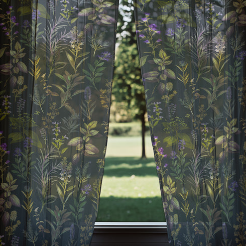 Sheer curtain panel featuring an intricate vertical pattern of wild botanicals including purple flowers, golden leaves, and silvery fronds against a dark charcoal background. The design shows detailed herbarium-style illustrations.