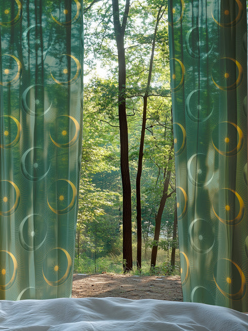 Sheer forest green curtain panel featuring repeating pattern of golden suns and silver moons with radiating lines, creating an elegant celestial motif against translucent fabric.
