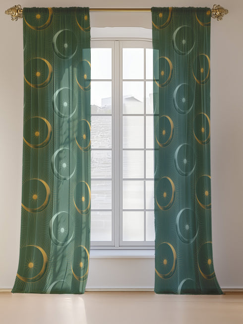 Sheer forest green curtain panel featuring repeating pattern of golden suns and silver moons with radiating lines, creating an elegant celestial motif against translucent fabric.