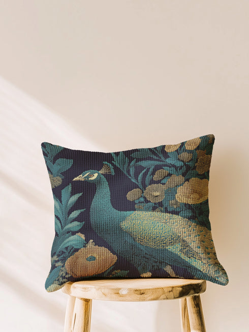 Elegant peacock woven pillow featuring detailed turquoise and teal peacock surrounded by vintage botanical florals in golden amber and bronze tones against navy background, expertly crafted from cotton-polyester blend with fine weaving technique, measuring 17x18 inches, USA-made double-sided throw pillow perfect for bohemian home decor, living rooms, or nature-inspired interior design seeking sophisticated artistic accent pieces
