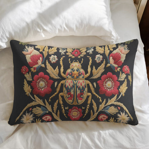 A rectangular black lumbar pillow with a premium linen-feel texture. The pillow features a detailed, tapestry-style Art Nouveau print of a large scarab beetle at its center. The beetle and surrounding symmetrical floral and botanical motifs are rendered in rich colors of antique gold, deep crimson red, and muted teal. This ornate, maximalist design is set against a dark charcoal black background, creating a moody, gothic, & scholarly aesthetic suitable for dark academia or victorian home decor.