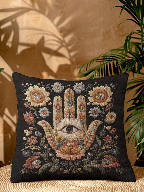 Mystical hamsa hand decorative woven pillow featuring intricate tapestry-style design with protective eye symbol surrounded by delicate floral motifs in warm earth tones including golden amber, soft blues, coral pinks, and sage greens against rich black background, expertly crafted from cotton-polyester blend with fine weaving technique, measuring 17x18 inches, USA-made double-sided throw pillow perfect for bohemian spiritual home decor, meditation spaces, or eclectic living rooms seeking meaningful artisti