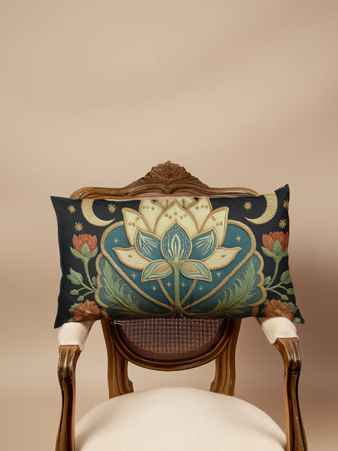 Lotus Lumbar Premium PillowA rectangular lumbar pillow in a dark, moody Art Nouveau style. The design features a large, central lotus flower in cream and teal, set against a deep navy blue background. The lotus is framed by intricate, flowing golden lines characteristic of the Art Nouveau period. On either side of the central flower are golden crescent moons and small stars, creating a celestial theme. The pillow has a visible, tactile texture that resembles a vintage linen or tapestry fabric.