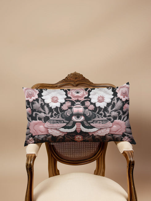 Gothic moth eye botanical lumbar pillow with mystical embroidered wings on dark fabric. Cottagecore throw pillow featuring protective moth symbol surrounded by pink roses, white wildflowers & sacred botanicals. Witchy home decor with medieval tapestry aesthetic. Perfect for dark academia spaces, bohemian decor & occult art lovers. 20x12 lumbar size.