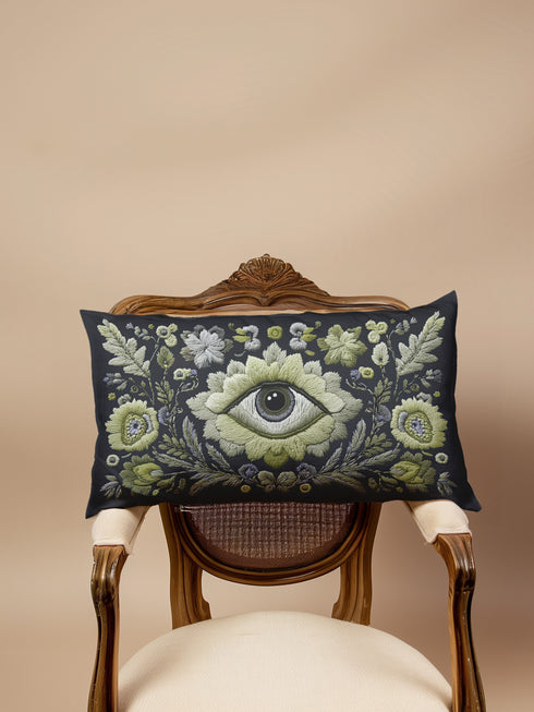 All-seeing eye botanical lumbar pillow with mystical herbal embroidery on dark navy fabric. Gothic cottagecore throw pillow featuring protective third eye symbol surrounded by sage botanicals, oak leaves & wildflowers. Witchy home decor with medieval tapestry aesthetic. Perfect for bohemian spiritual spaces, pagan decor & occult art lovers. 20x12 lumbar size.