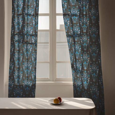 A sheer curtain panel featuring a repeating pattern of stylized owls in luminous blue tones, surrounded by delicate botanical flowers and flourishes on a dark background.