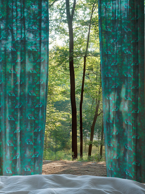A sheer curtain panel in emerald green featuring a repeating pattern of raven silhouettes and Victorian botanical fan motifs. The fabric has a semi-transparent, linen-like texture.