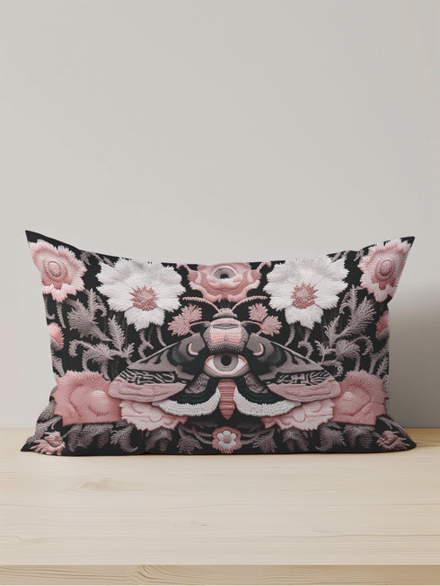 Gothic moth eye botanical lumbar pillow with mystical embroidered wings on dark fabric. Cottagecore throw pillow featuring protective moth symbol surrounded by pink roses, white wildflowers & sacred botanicals. Witchy home decor with medieval tapestry aesthetic. Perfect for dark academia spaces, bohemian decor & occult art lovers. 20x12 lumbar size.